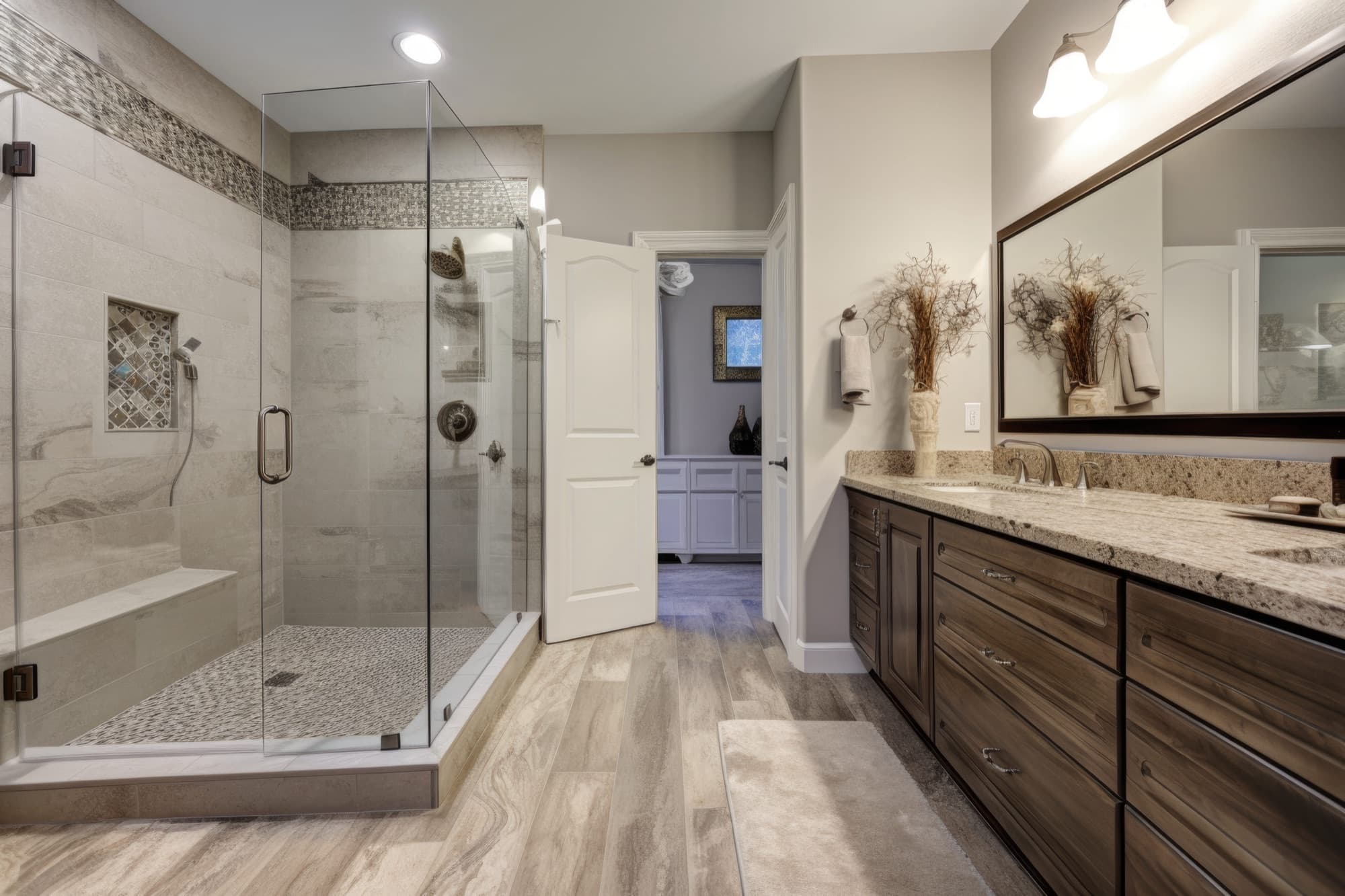 Remodeled bathroom with glass shower and double vanity