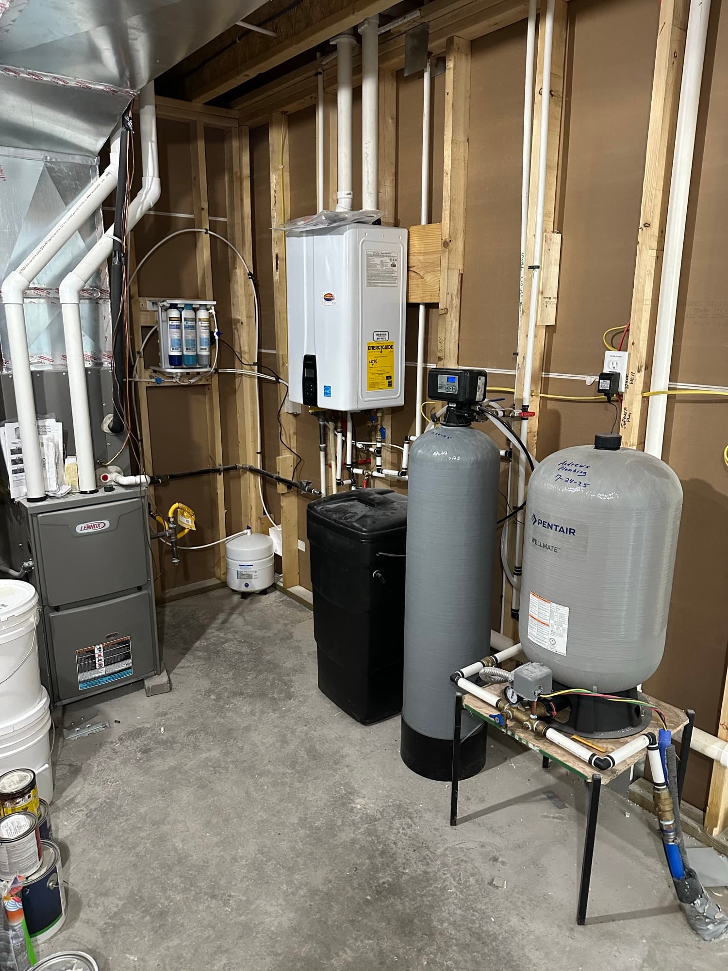 Water heater and water softener tanks installed by Andrews Plumbing
